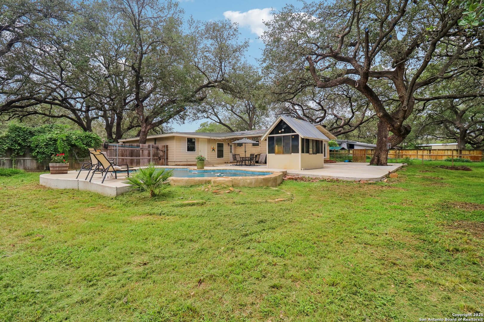 503 Mockingbird Lane Devine, TX 78016 - Photo 34 of 49 a front view of a house with a garden and trees