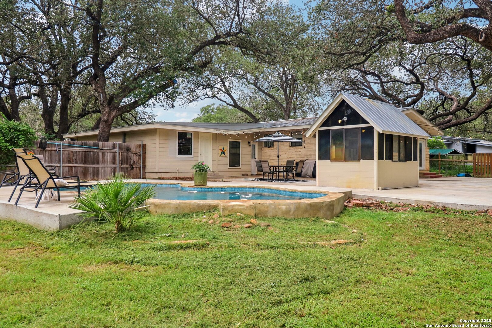 503 Mockingbird Lane Devine, TX 78016 - Photo 35 of 49 a front view of a house with a yard garage and outdoor seating