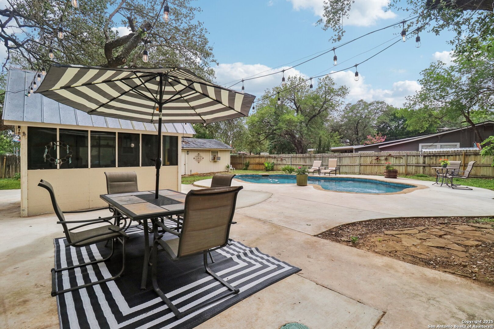 503 Mockingbird Lane Devine, TX 78016 - Photo 38 of 49 a view of a patio with a dining table and chairs with wooden floor