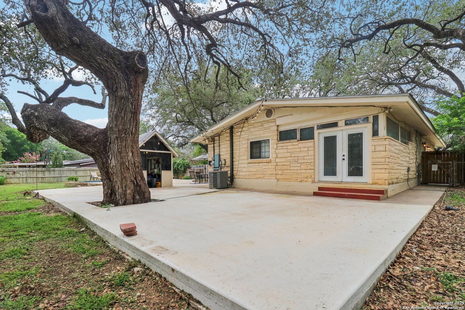503 Mockingbird Lane Devine, TX 78016 - Photo 40 of 49 a front view of a house with yard tree and wooden fence