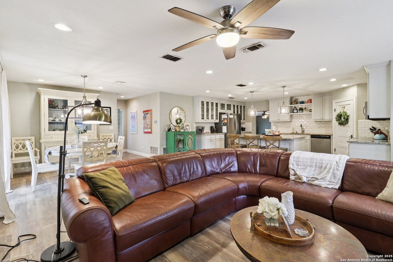 503 Mockingbird Lane Devine, TX 78016 - Photo 5 of 49 a living room with furniture kitchen view and a chandelier