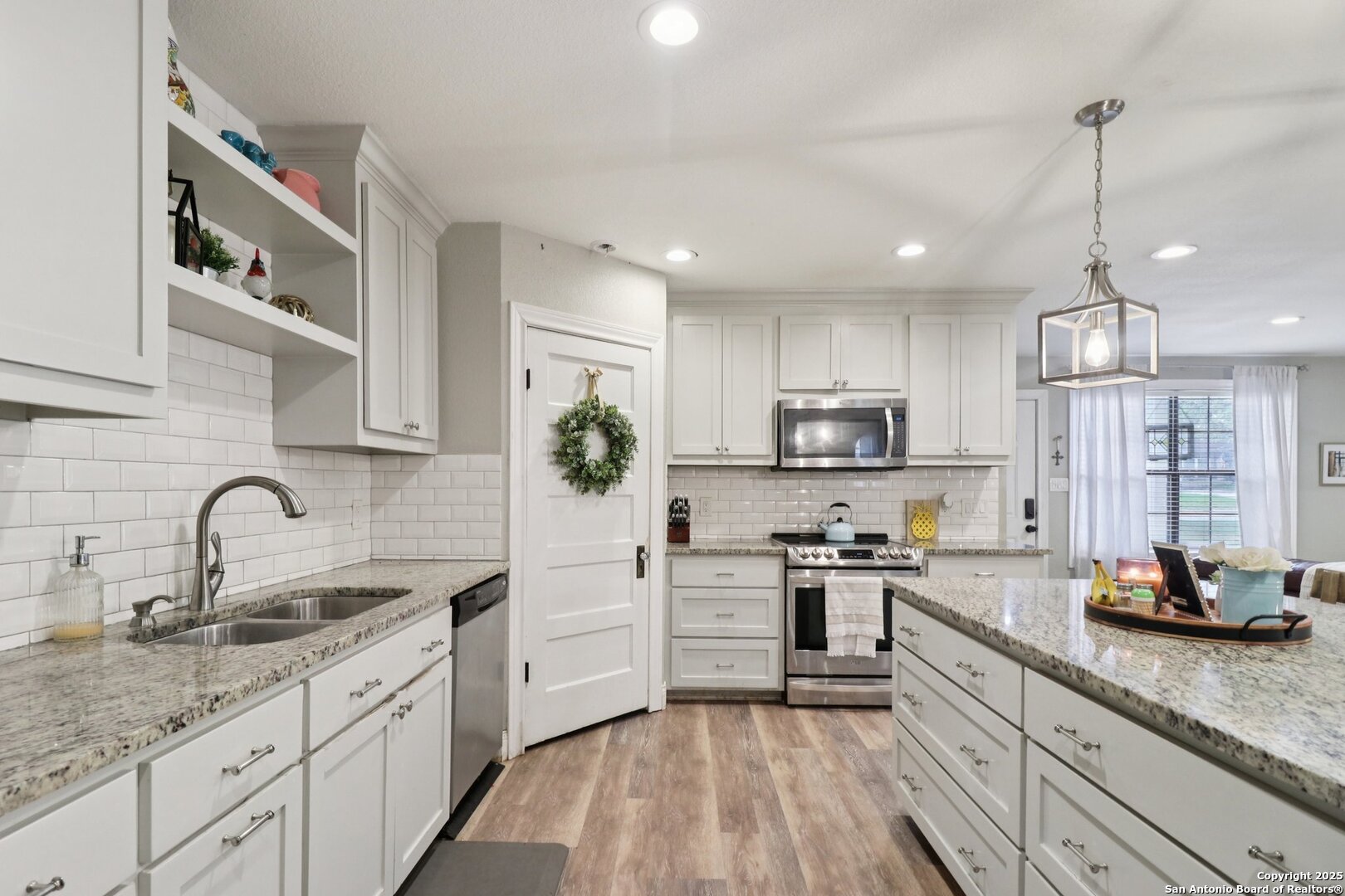 503 Mockingbird Lane Devine, TX 78016 - Photo 10 of 49 a kitchen with stainless steel appliances a sink stove and refrigerator