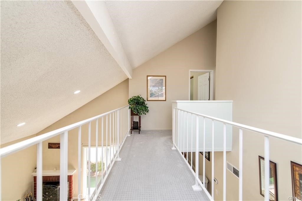 12441 Interior Circle Los Alamitos, CA 90720 - Photo 16 of 26 a view of a hallway with wooden floor and stairs