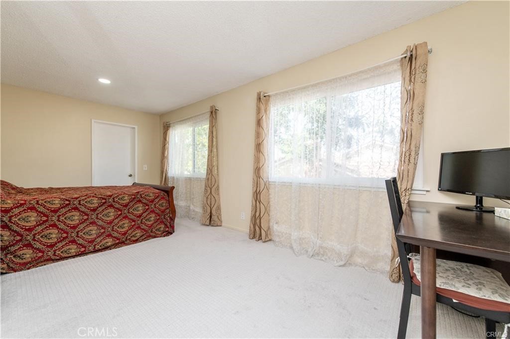 12441 Interior Circle Los Alamitos, CA 90720 - Photo 20 of 26 a bedroom with a bed and a flat screen tv