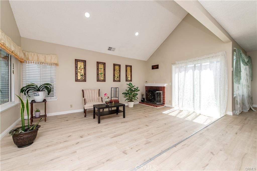 12441 Interior Circle Los Alamitos, CA 90720 - Photo 4 of 26 a living room with furniture potted plant and a fireplace