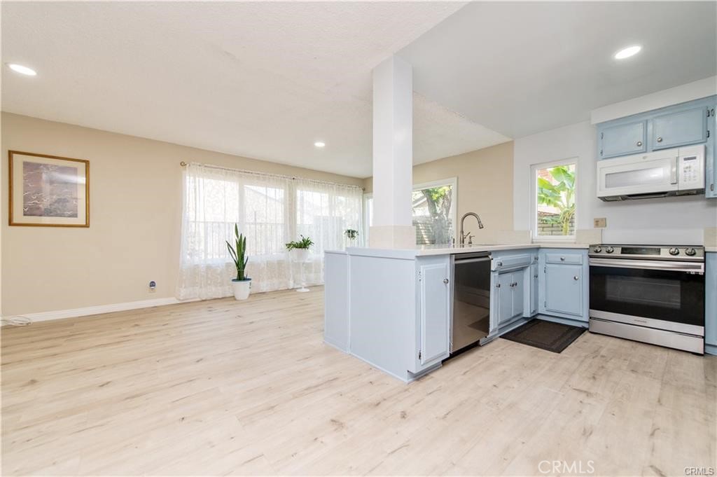 12441 Interior Circle Los Alamitos, CA 90720 - Photo 7 of 26 a kitchen with stainless steel appliances granite countertop a stove a sink and a refrigerator