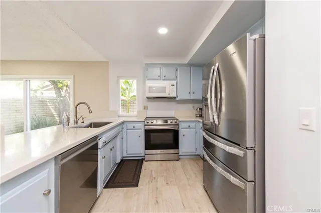a kitchen with a sink and a refrigerator