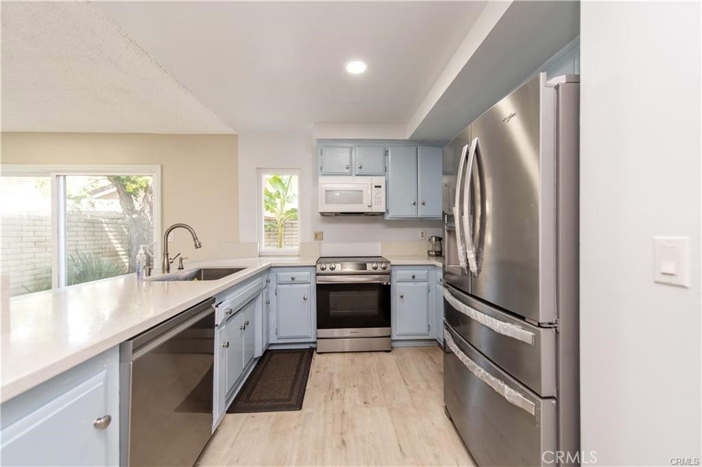 12441 Interior Circle Los Alamitos, CA 90720 - Photo 9 of 26 a kitchen with stainless steel appliances granite countertop a refrigerator and a sink