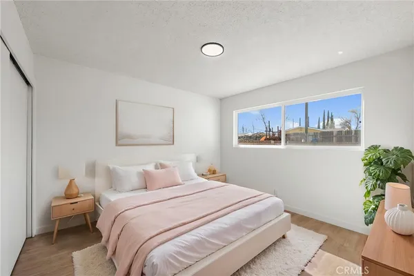 a bedroom with a bed and a painting on the wall