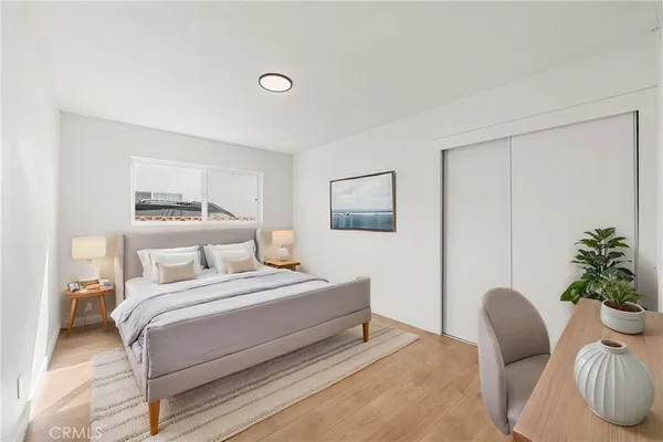 a bedroom with a bed and a potted plant