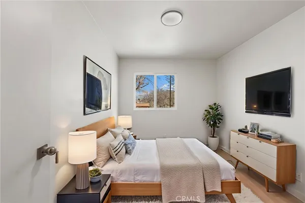 a bedroom with a bed and a flat screen tv