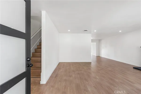 a view of hallway with wooden floor