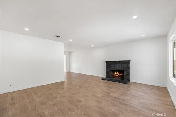 a view of an empty room with a fireplace