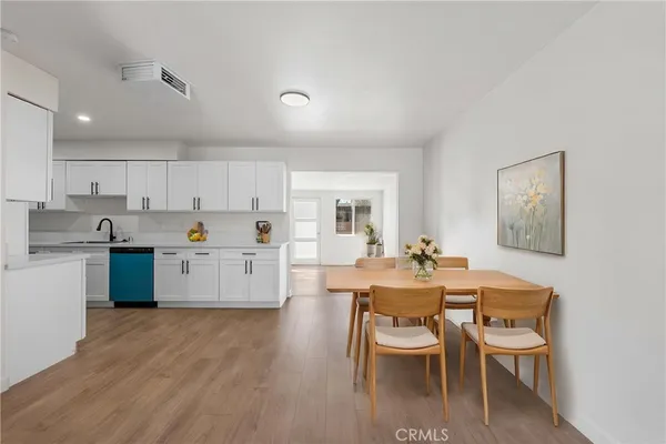 a view of kitchen with cabinets table and chairs