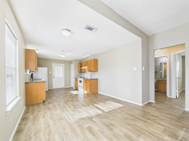 a view of a big room with wooden floor and cabinet