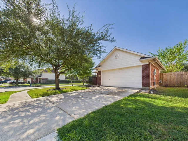 a house that has a big yard and large trees