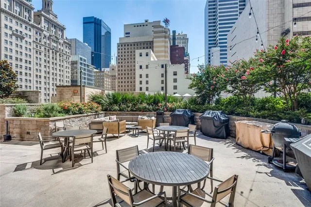 a view of a patio with a table and chairs next to a road
