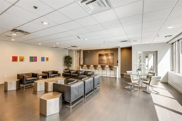 a large white kitchen with lots of counter top space and stainless steel appliances