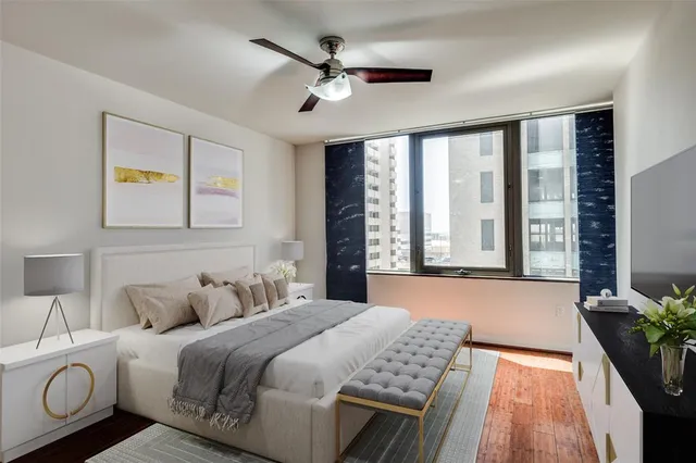 a bedroom with a bed and a large window