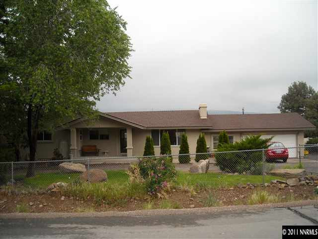 14215 Virginia Foothills Drive Reno, NV 89521 - Photo 1 of 12 a front view of a house with garden
