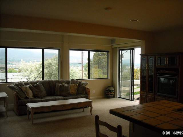 14215 Virginia Foothills Drive Reno, NV 89521 - Photo 2 of 12 a living room with furniture and a large window