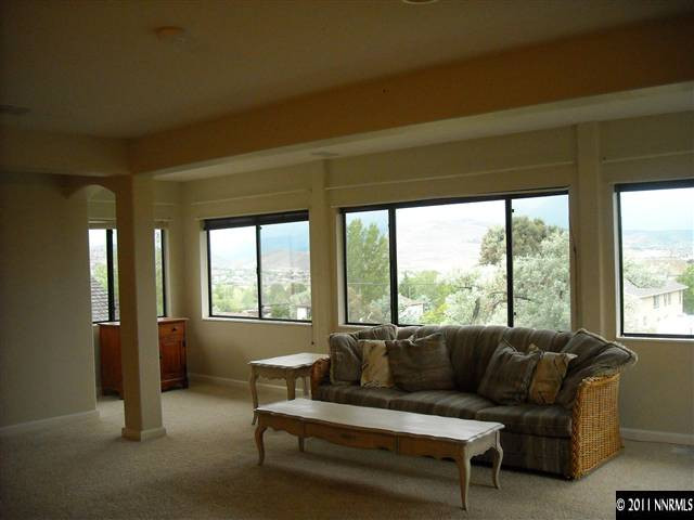 14215 Virginia Foothills Drive Reno, NV 89521 - Photo 3 of 12 a living room with furniture and a large window