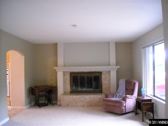 14215 Virginia Foothills Drive Reno, NV 89521 - Photo 4 of 12 a living room with furniture and a fireplace
