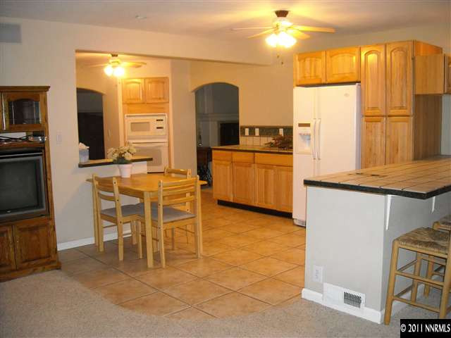 14215 Virginia Foothills Drive Reno, NV 89521 - Photo 6 of 12 a large kitchen with a table and chairs in it