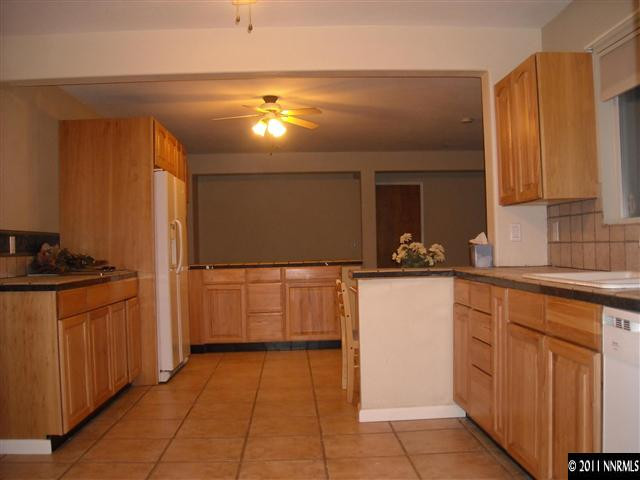 14215 Virginia Foothills Drive Reno, NV 89521 - Photo 7 of 12 a kitchen with a sink and cabinets