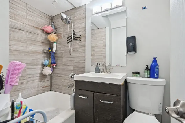 a bathroom with a sink vanity mirror and toilet
