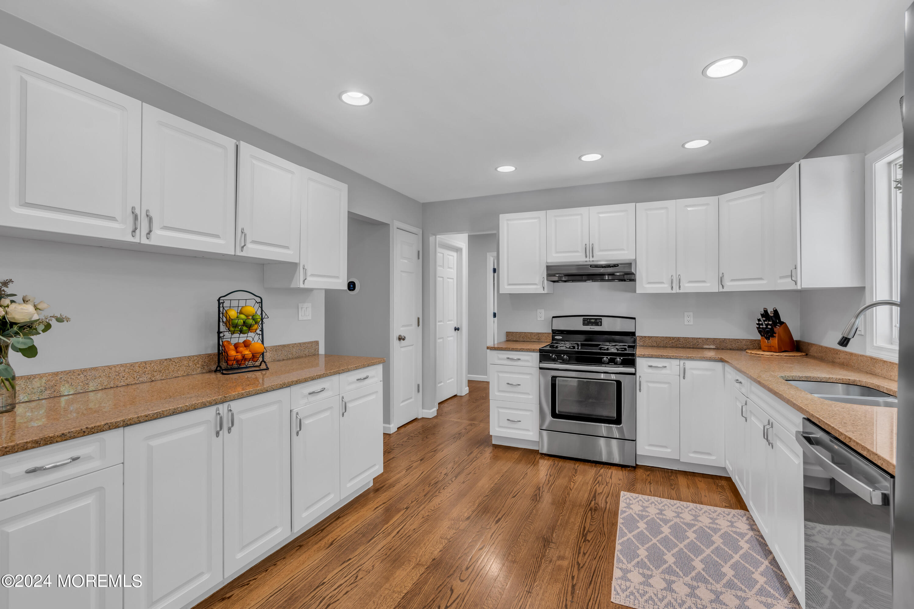 104 Five Points Road Colts Neck, NJ 07722 - Photo 13 of 46 a kitchen with granite countertop white cabinets and stainless steel appliances