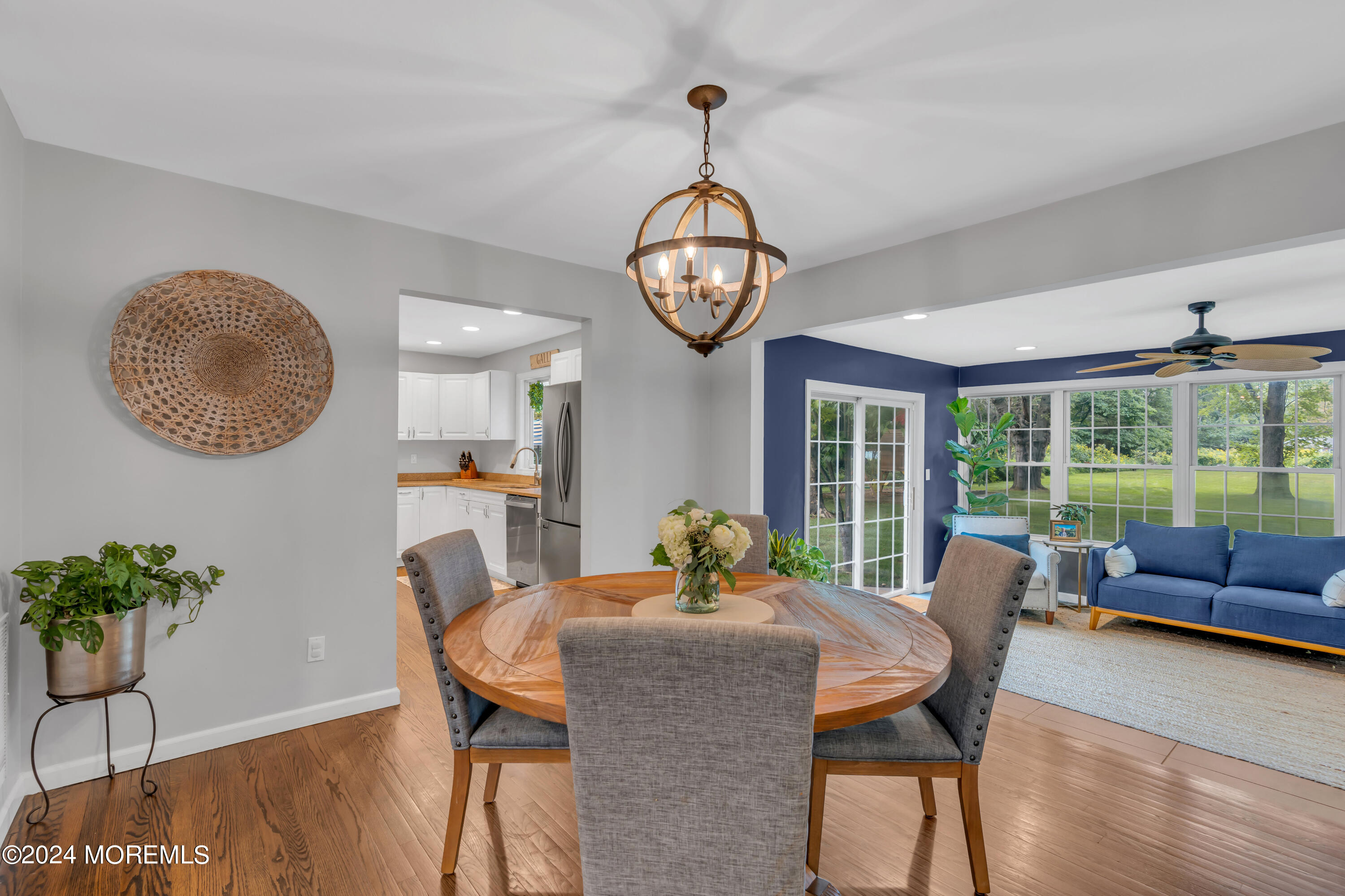 104 Five Points Road Colts Neck, NJ 07722 - Photo 18 of 46 a dining room with furniture a potted plant and a chandelier