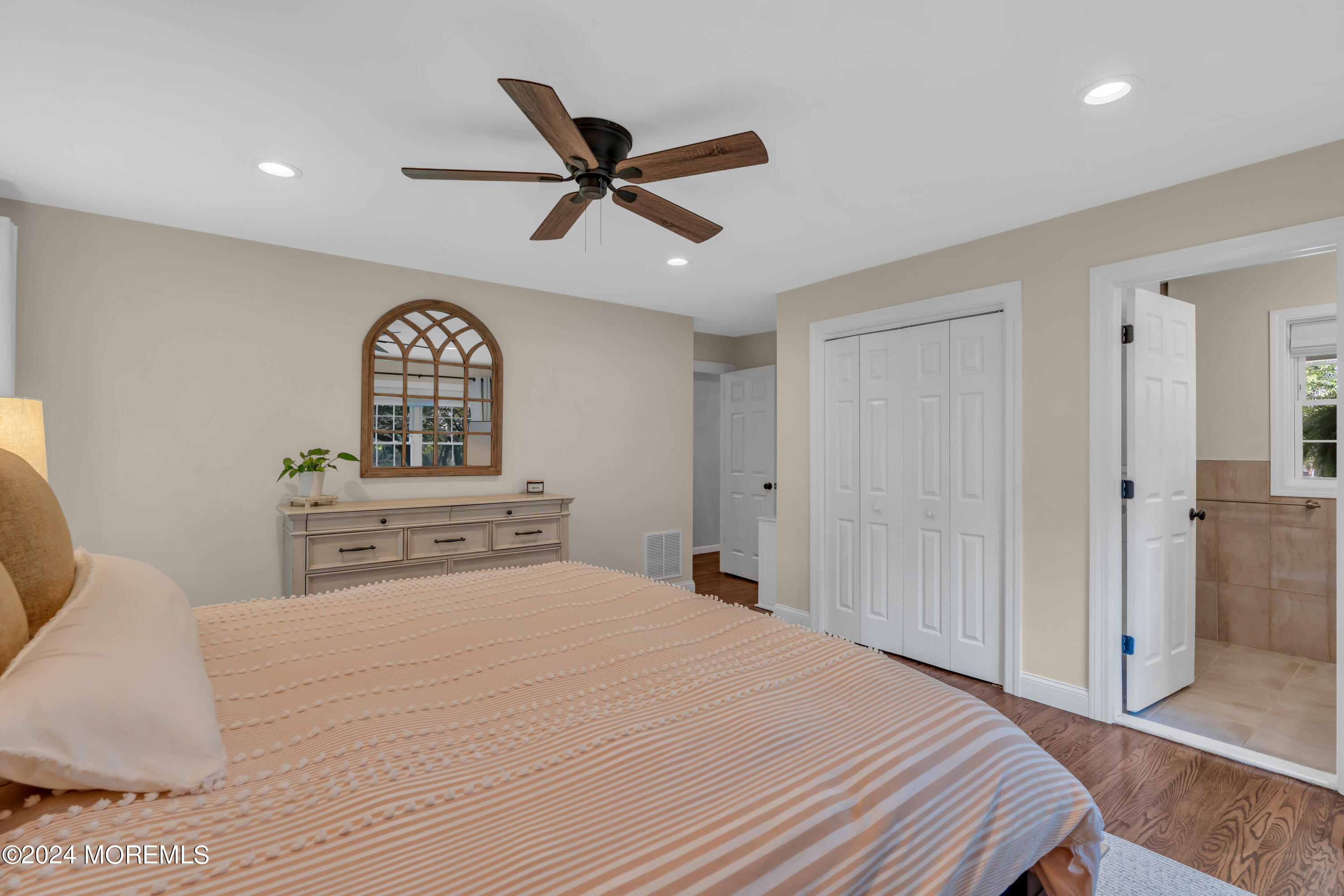 104 Five Points Road Colts Neck, NJ 07722 - Photo 30 of 46 a bedroom with a bed and a chandelier