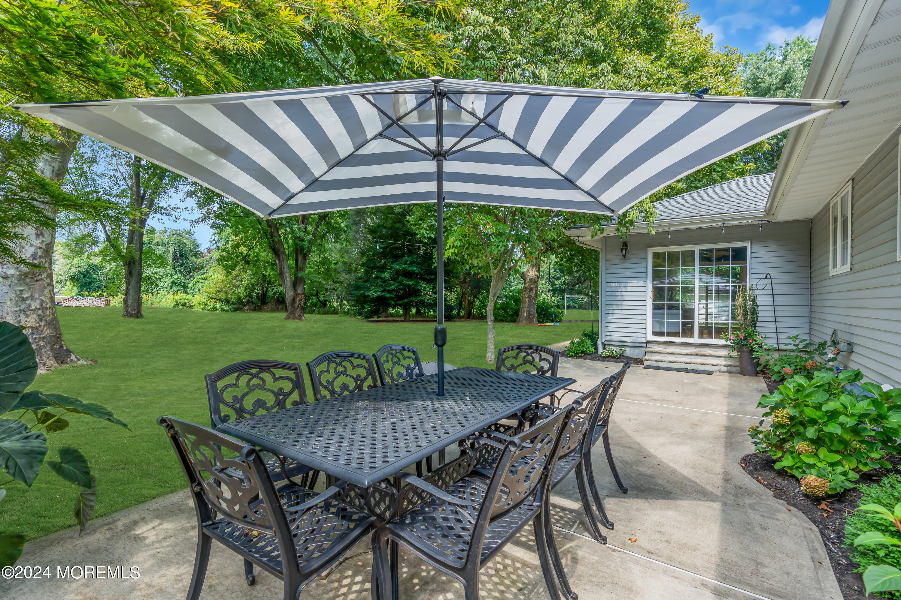 104 Five Points Road Colts Neck, NJ 07722 - Photo 39 of 46 a view of a table and chairs in backyard of the house