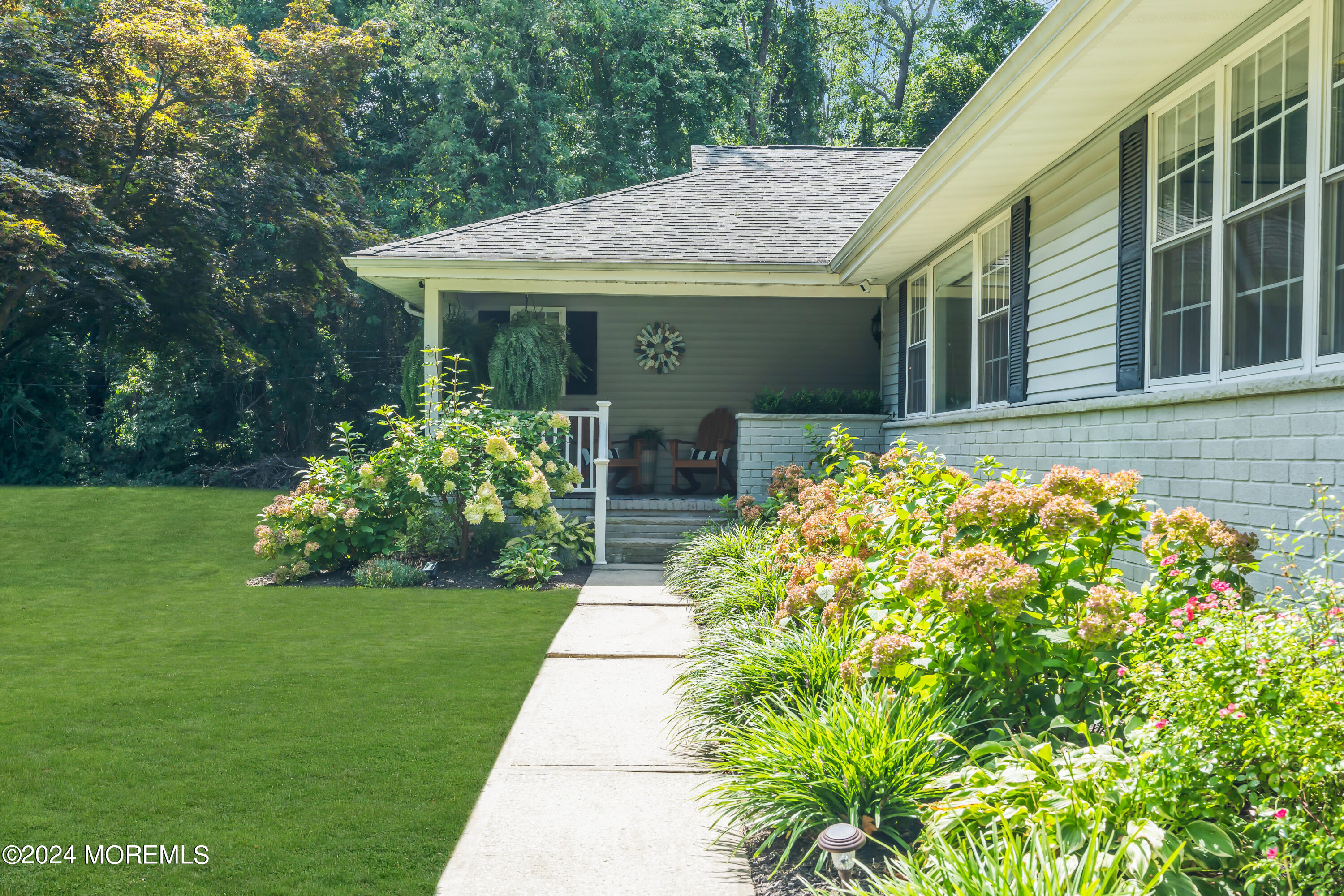 104 Five Points Road Colts Neck, NJ 07722 - Photo 4 of 46 a front view of a house with garden