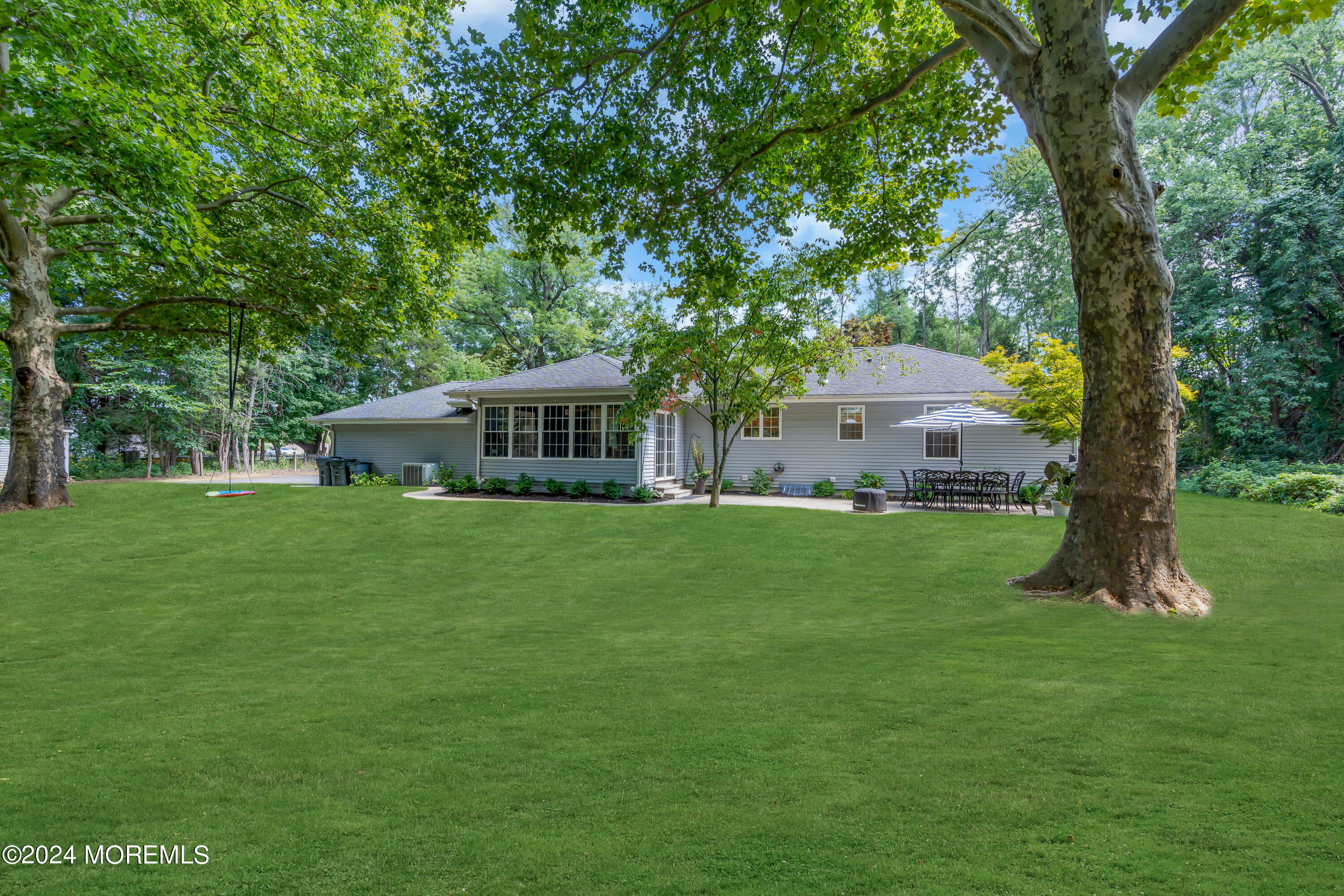 104 Five Points Road Colts Neck, NJ 07722 - Photo 42 of 46 a front view of a house with a garden