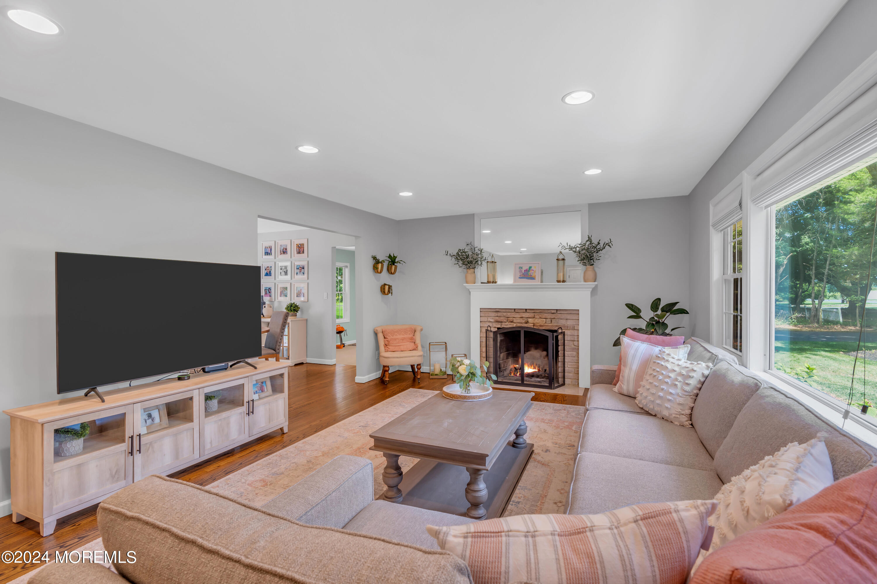 104 Five Points Road Colts Neck, NJ 07722 - Photo 9 of 46 a living room with furniture a flat screen tv and a fireplace