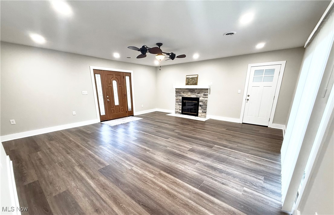4670 Sandy Lake Road Ravenna, OH 44266 - Photo 2 of 26 Unfurnished living room with ceiling fan, recessed lighting, dark wood-style flooring, a fireplace, and baseboards