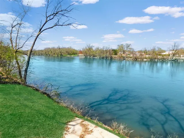 a view of a lake with houses in the back
