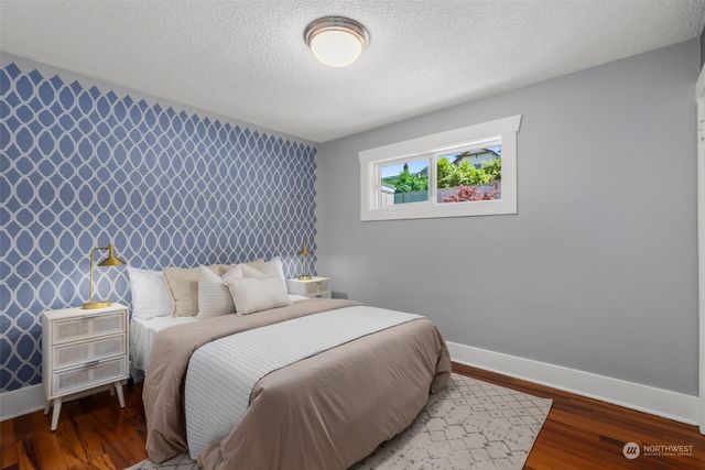 a bedroom with a bed and a painting on the wall