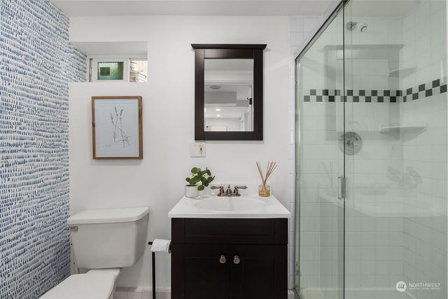 a bathroom with a sink mirror toilet and vanity
