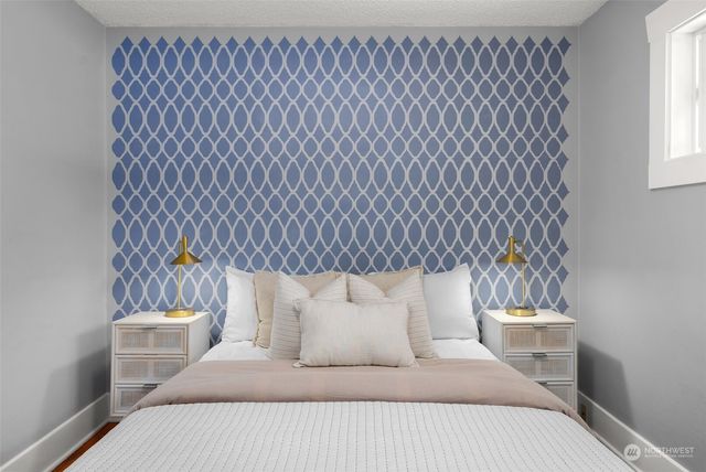 a bedroom with a bed and a chair