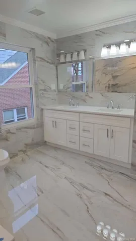 a bathroom with a double vanity sink and a mirror