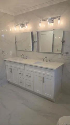 a bathroom with a granite countertop sink a toilet and a shower