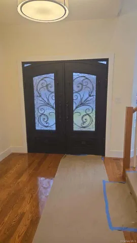 a view of a hallway with wooden floor and staircase
