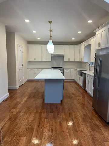 an empty room with windows and fireplace