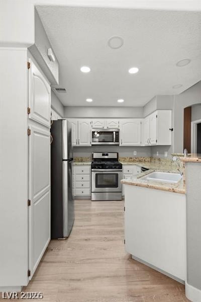 3320 South Fort Apache Road, Unit 125 Las Vegas, NV 89117 - Photo 9 of 26 A pristine kitchen offers ample white cabinetry and stainless-steel appliances.