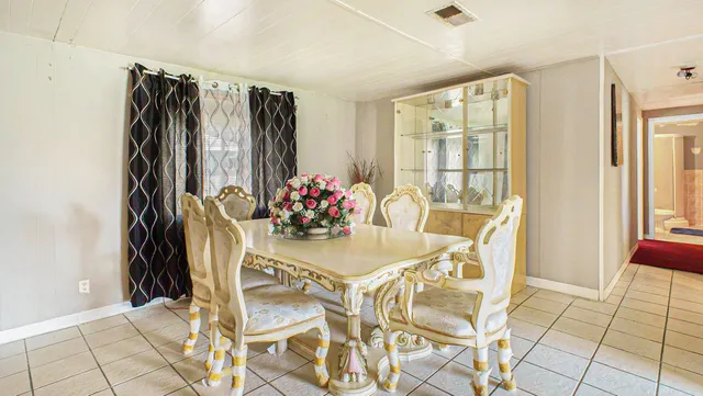 a dining room with furniture and window