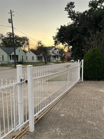 a view of a house with iron fence