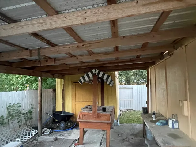 a view of a porch with furniture and next to window